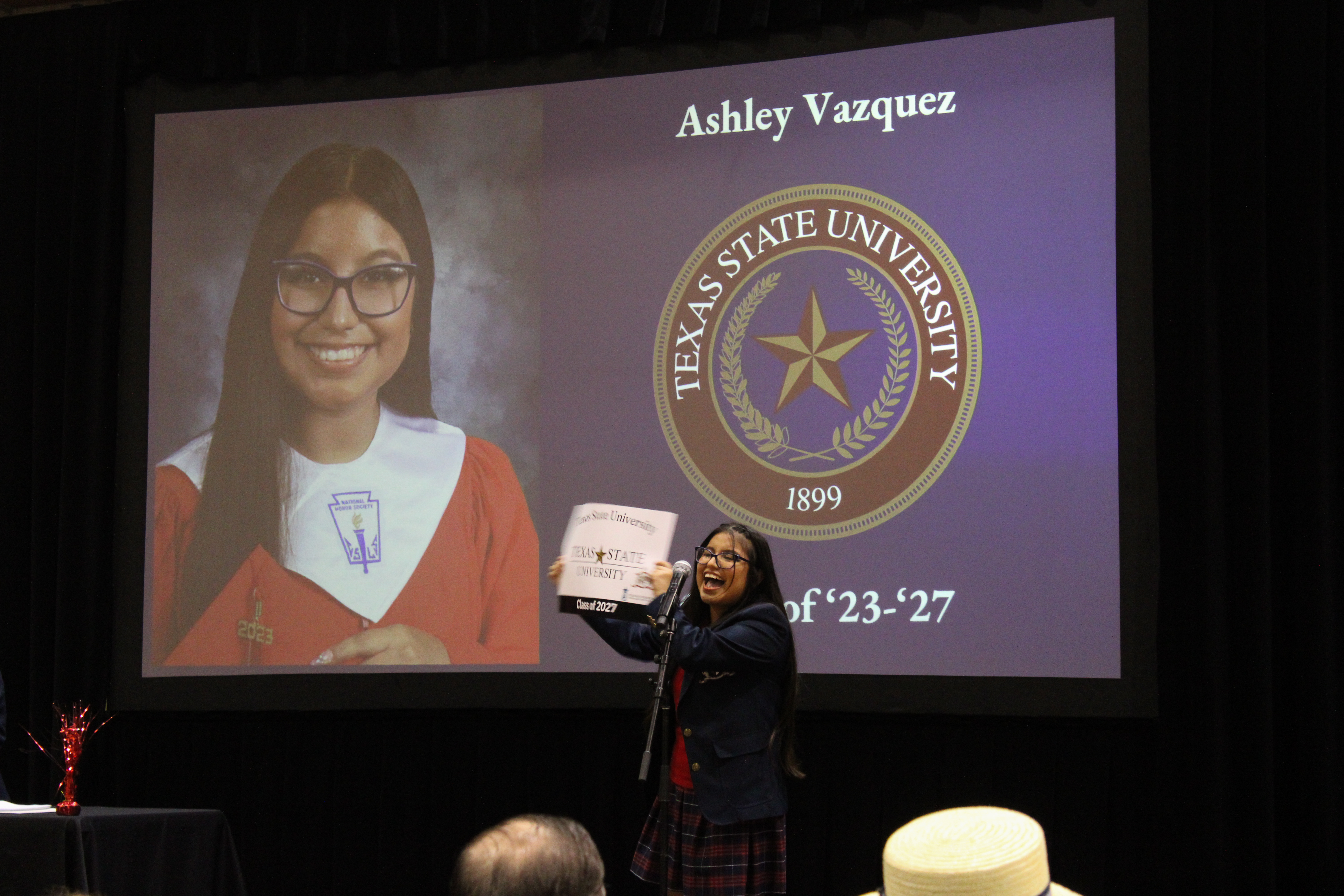 Picture of Ashley Vazquez holding Texas State Poster announcing where she is attending